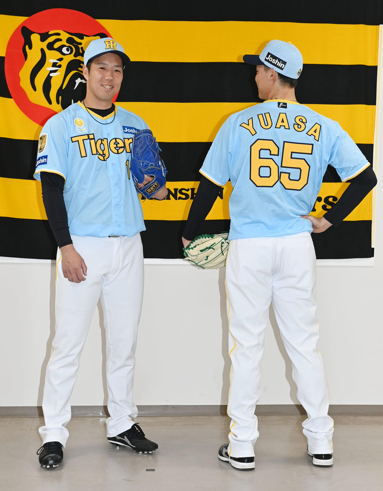 「Family with Tigers」の限定ユニホームを披露する阪神青柳（左）と湯浅（撮影・和賀正仁）