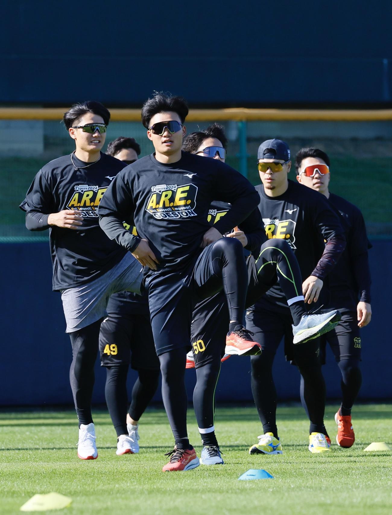 合同自主トレでアレTシャツを着てアップする森下翔太ら阪神ナイン（撮影・藤尾明華）