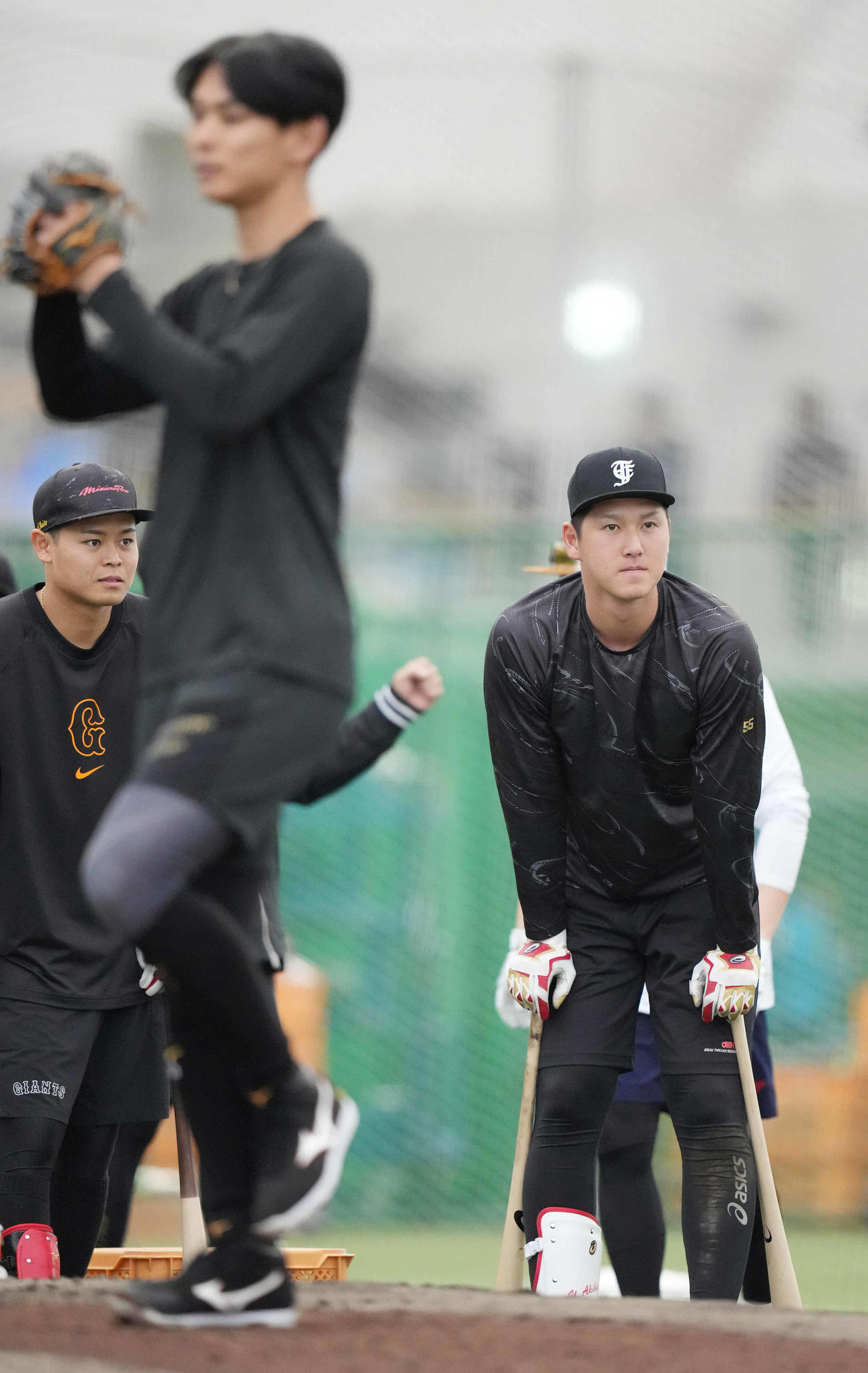 ブルペンで泉（手前）らの投球を見る巨人秋広（撮影・鈴木みどり）