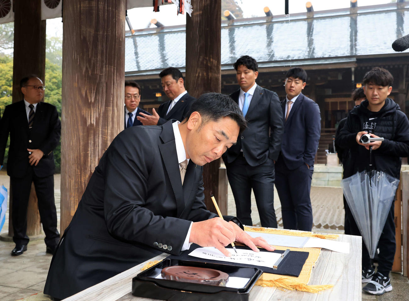 宮崎神宮に参拝した巨人阿部監督は、毛筆で記帳する（撮影・浅見桂子）