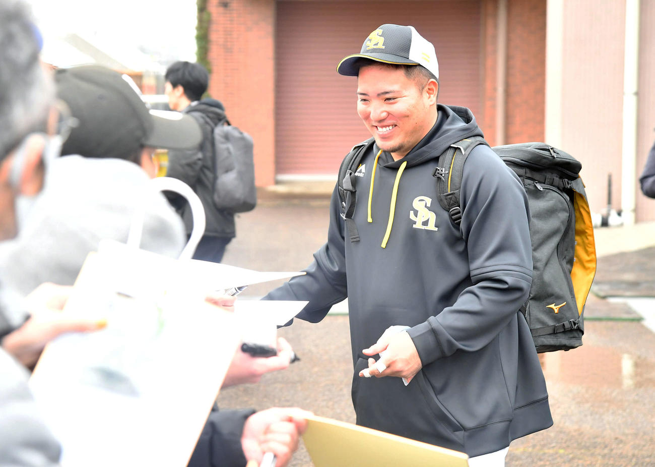笑顔でサイン会を行うソフトバンク山川（撮影・岩下翔太）