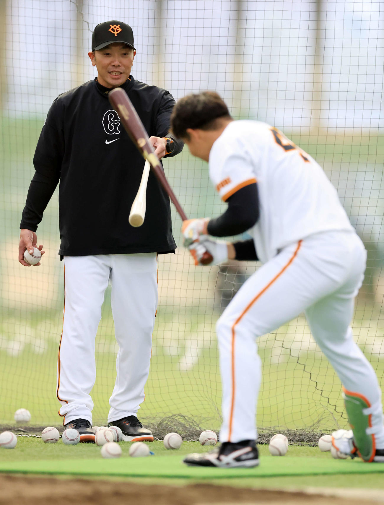 マンツーマンで巨人佐々木（手前）を打撃指導する阿部監督（撮影・浅見桂子）