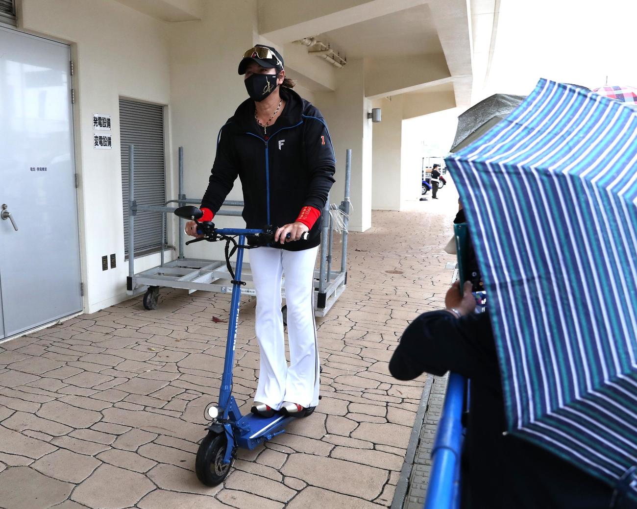 雨でもキックボードで球場入りする日本ハム新庄監督（撮影・黒川智章）