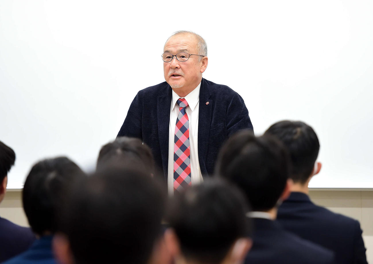 新入生オリエンテーションで話をする佐藤総監督