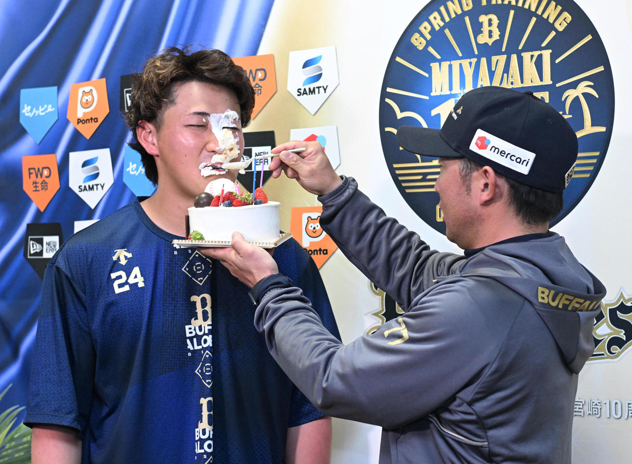 22歳の誕生日を迎え、オリックス梵コーチ（右）から顔面にクリームを塗られる紅林（撮影・和賀正仁）