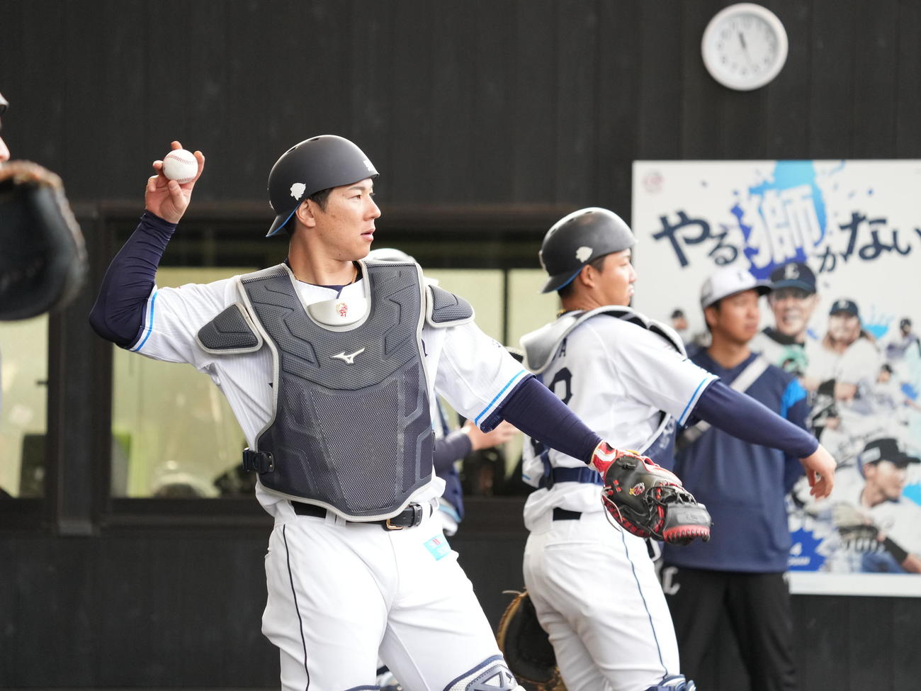 西武南郷キャンプ4日目、ブルペンで投球を受ける西武炭谷。右は古賀（撮影・小沢裕）