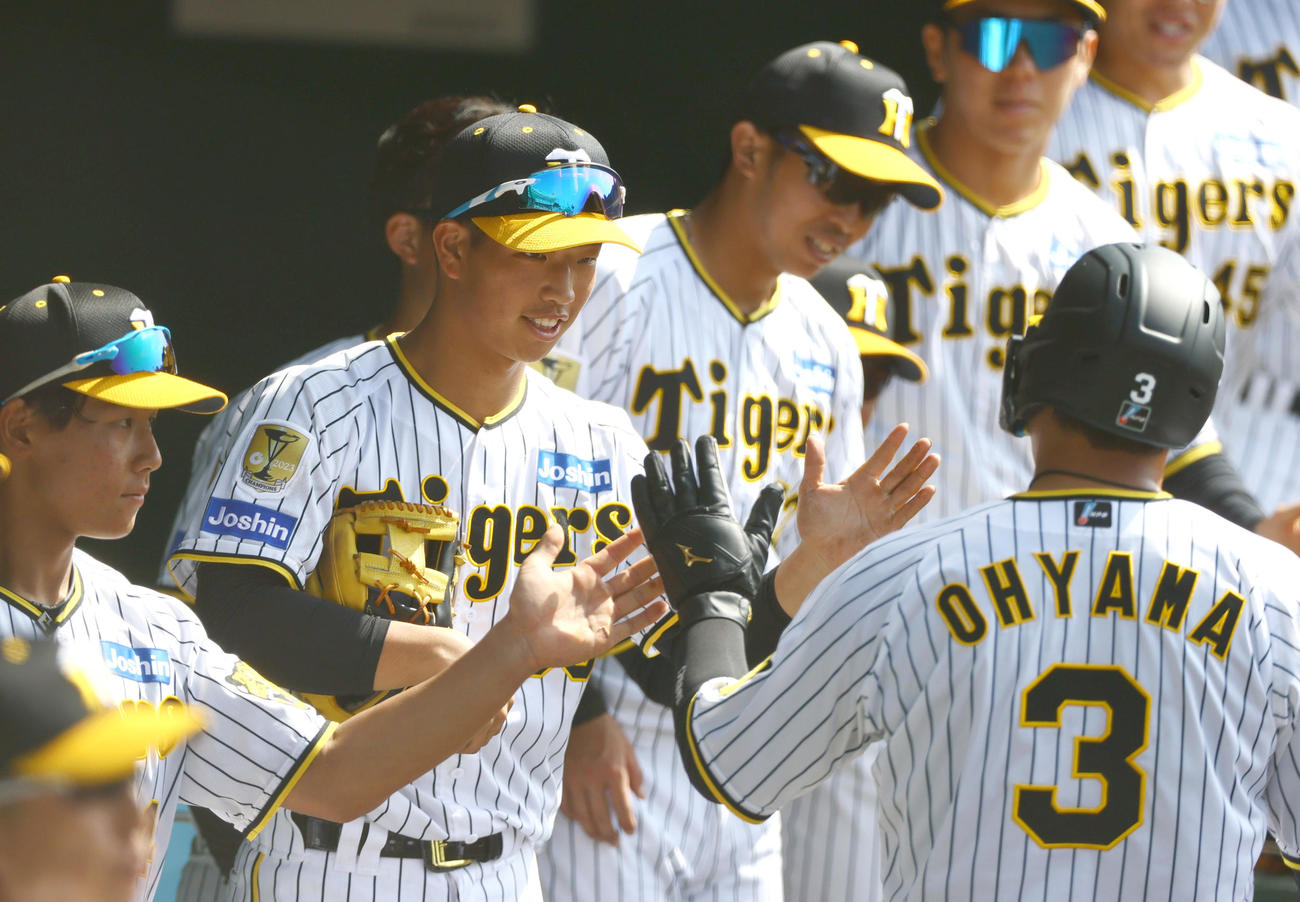 紅白戦　1回裏白組1死一、三塁、糸原健斗の三ゴロで生還した大山悠輔（右）を出迎える、左から戸井、百崎、島田、豊田ら（撮影・上山淳一）