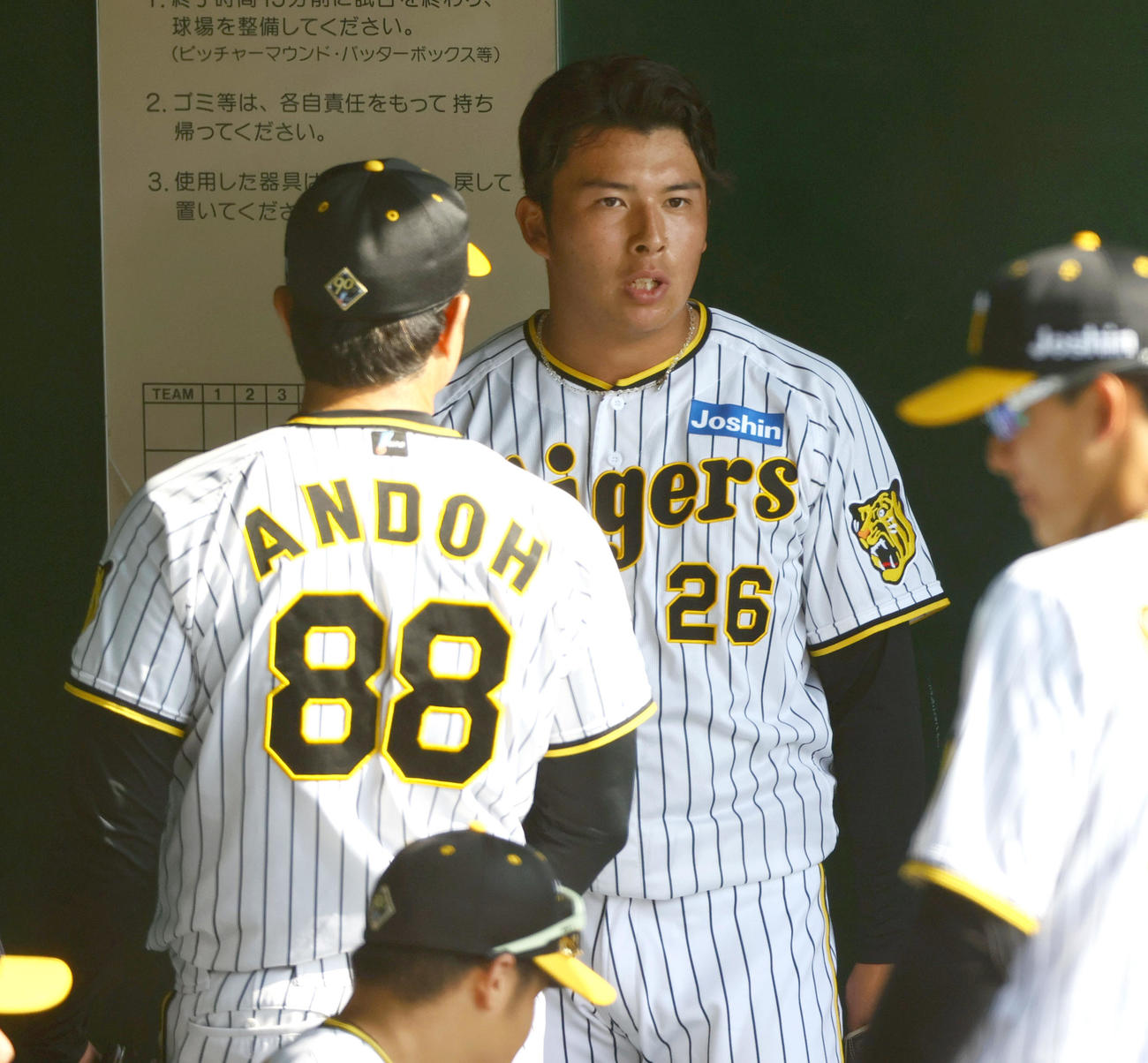 紅白戦　9回表に登板した白組椎葉（右）は無失点に抑えベンチで安藤投手コーチと話す（撮影・上山淳一）