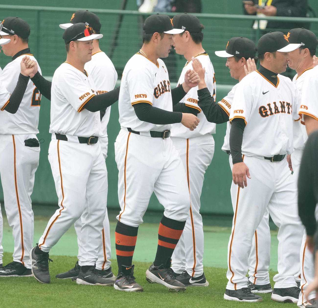 宮崎キャンプを打ち上げ、ハイタッチする巨人岡本和（中央）と阿部監督（右手前）（撮影・鈴木みどり）