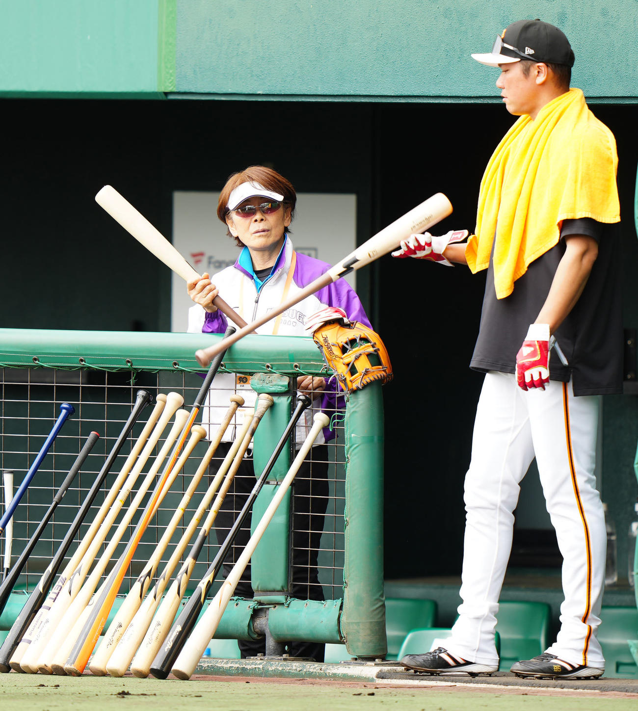巨人キャンプを訪れ、坂本（右）のバットを手にする宇津木さん（撮影・江口和貴）