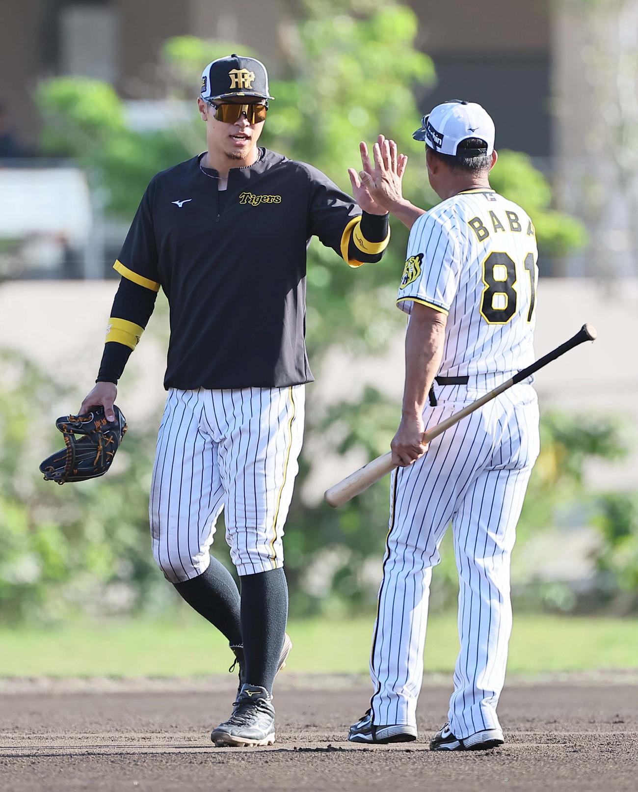 阪神対サムスン　ノックを終えた佐藤輝（左）は馬場コーチとハイタッチをする（撮影・上田博志）