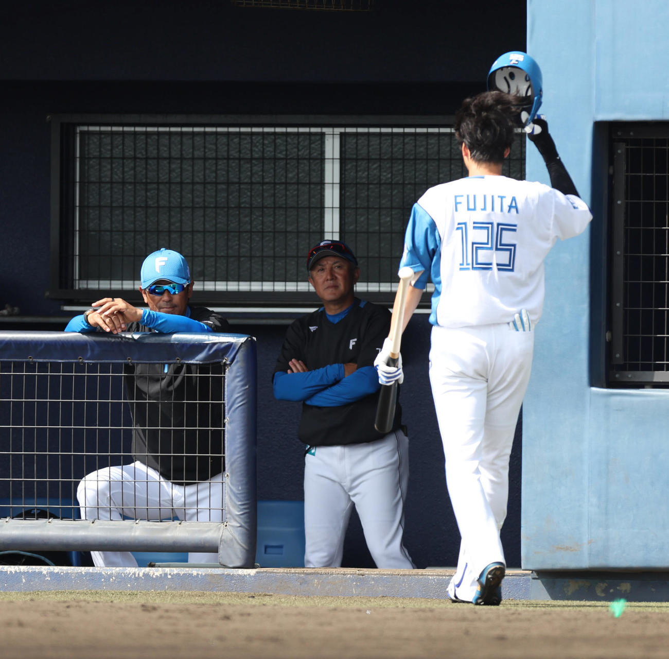 日本ハム対サムスン　2回裏日本ハム無死、三振に倒れベンチに戻る藤田。左は稲葉2軍監督（撮影・佐藤翔太）