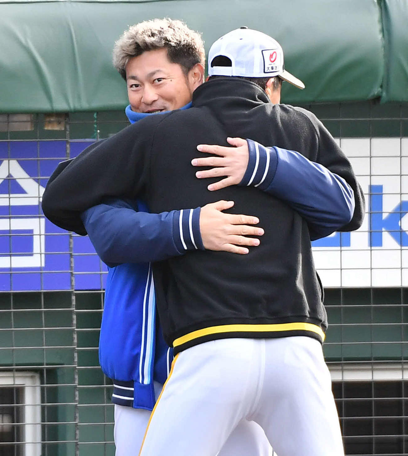 ソフトバンク対DeNA　試合前、ソフトバンク周東（右）から抱きつかれるDeNA森唯（撮影・岩下翔太）