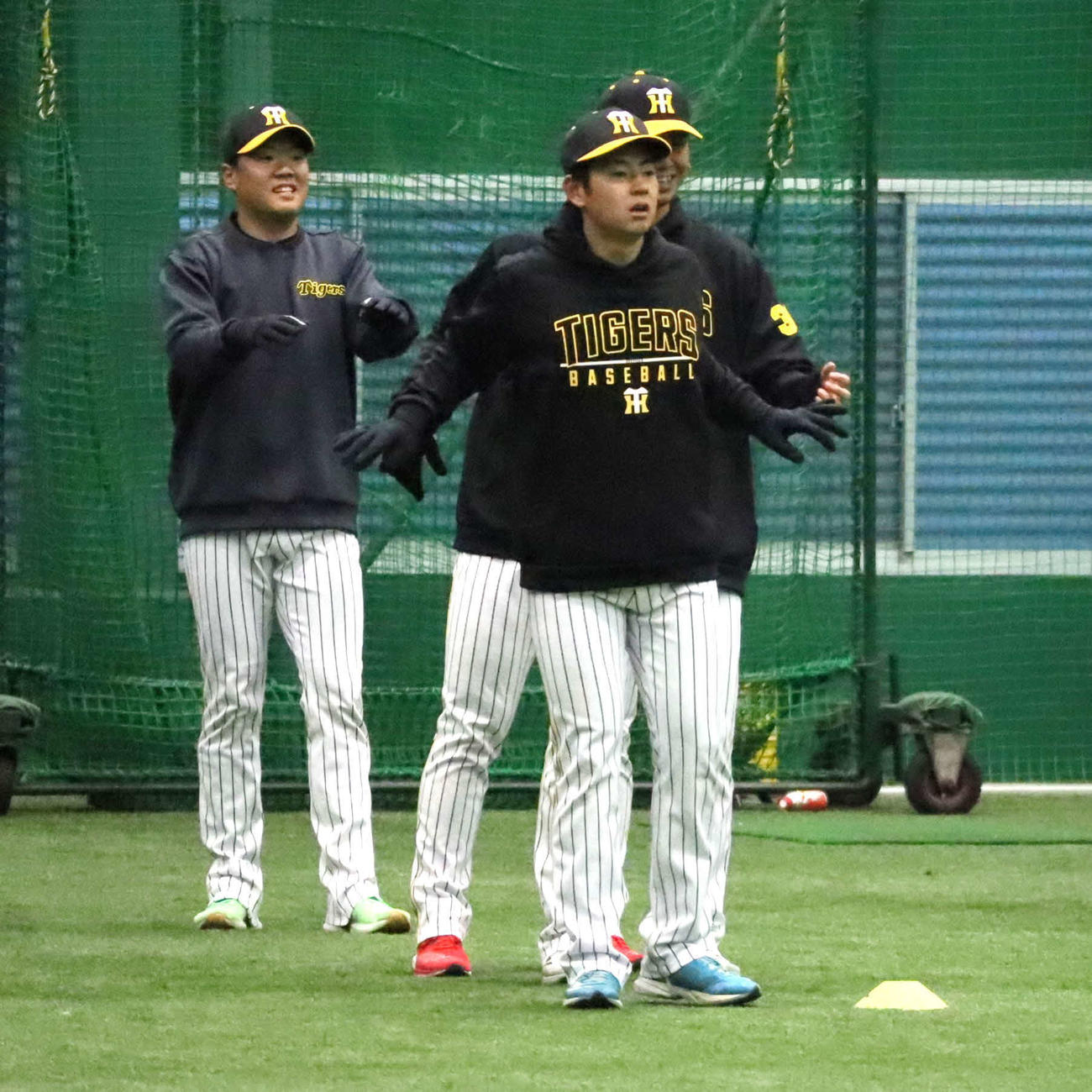 室内でウオーミングアップする阪神下村（右手前）（撮影・村松万里子）