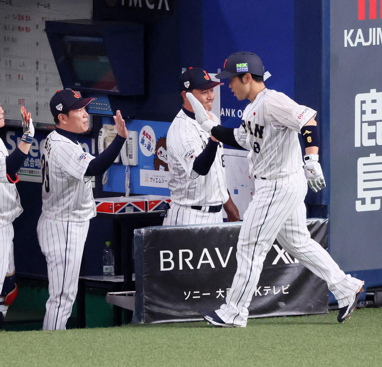 日本対欧州　1回裏日本2死一、三塁、三塁走者近藤は紅林弘太郎の右前適時打で生還し井端監督（左）とタッチ（撮影・加藤哉）