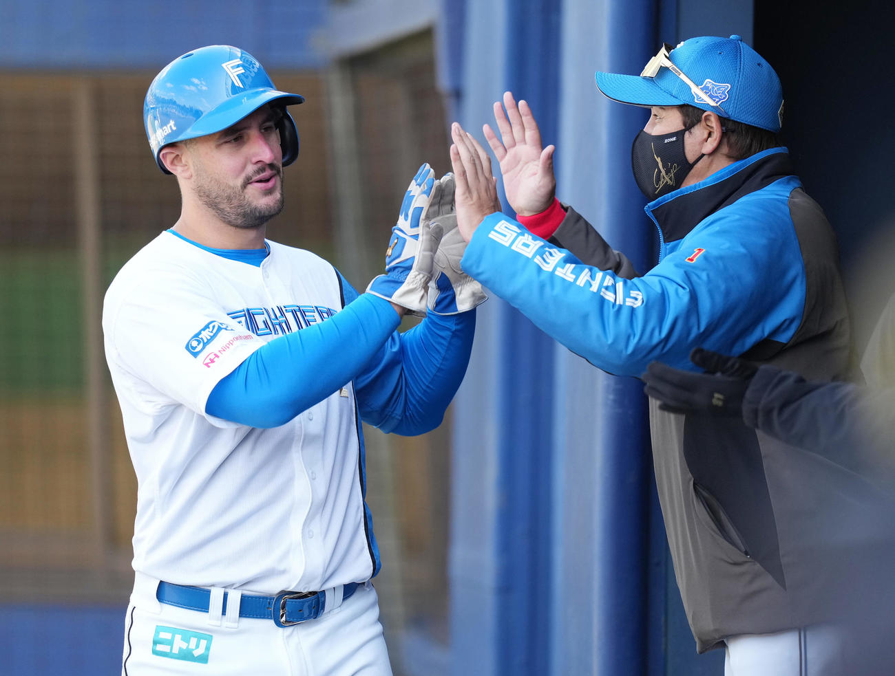 日本ハム対西武　3回裏日本ハム無死一、三塁、水野の投ゴロの間に生還した三塁走者マルティネス（左）は新庄監督とタッチを交わす（撮影・鈴木みどり）