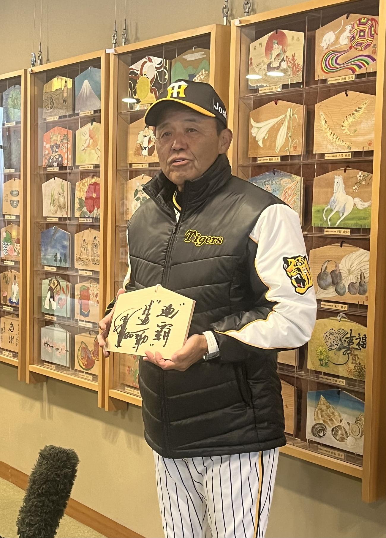 西宮神社での必勝祈願後に、自身が書いた絵馬を手に取材に応じる阪神岡田監督（撮影・磯綾乃）