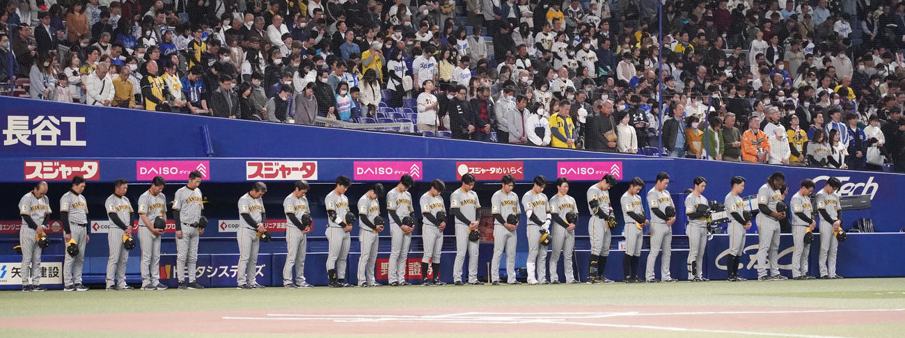 中日対阪神　中利夫氏追悼試合の前に黙とうする岡田監督ら阪神ナイン（撮影・森本幸一）
