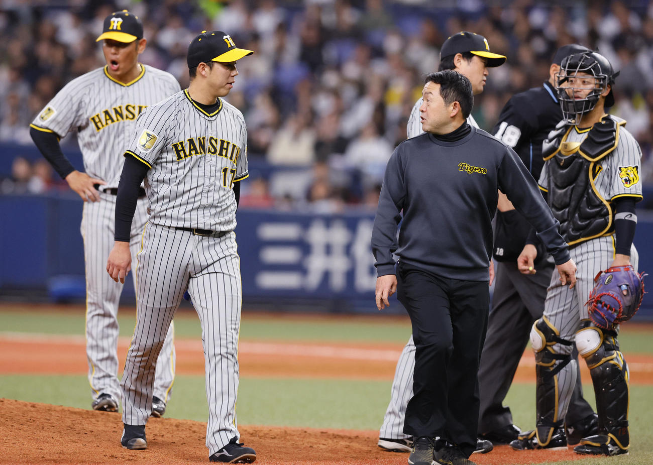 オリックス対阪神　4回裏オリックス無死、打者紅林弘太郎のとき、治療のためトレーナーとベンチに下がる青柳（左から2人目）（撮影・藤尾明華）