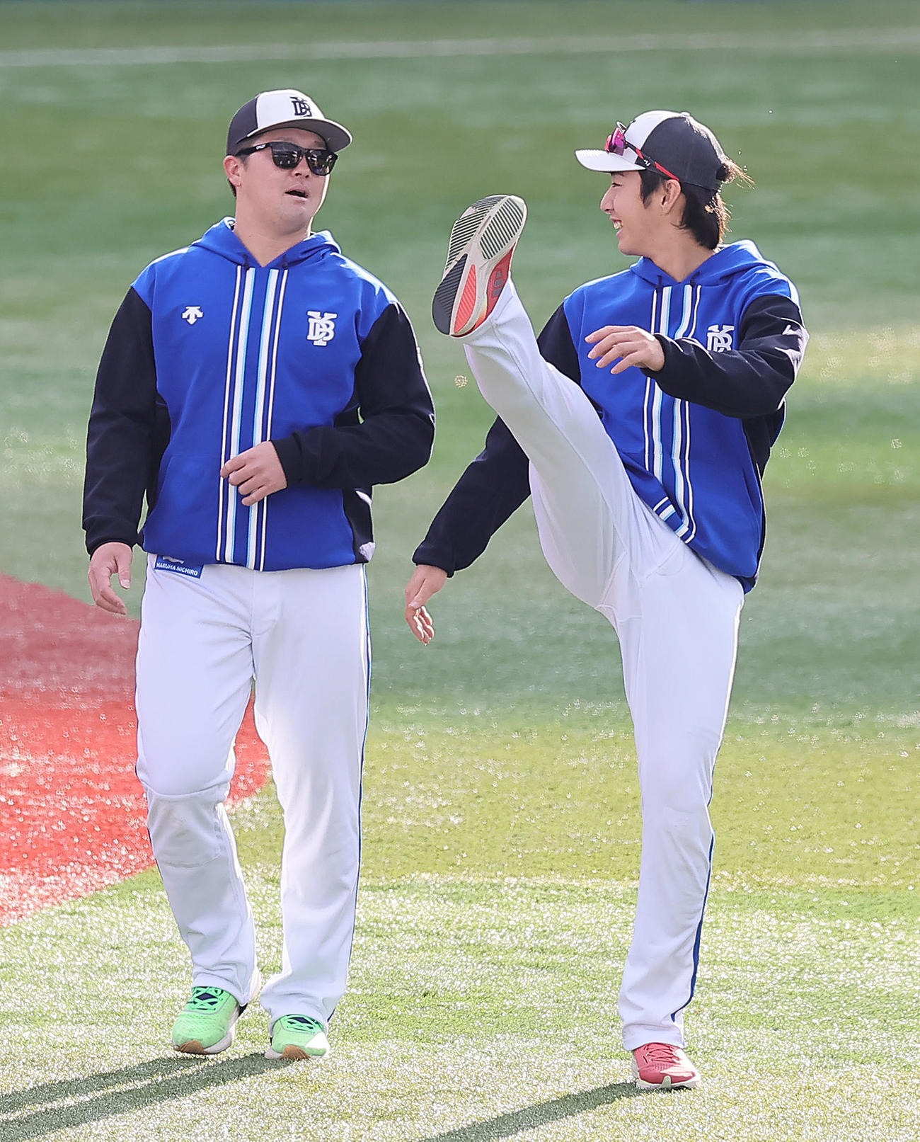 練習中、笑顔を見せるDeNAの牧（左）と度会（撮影・足立雅史）