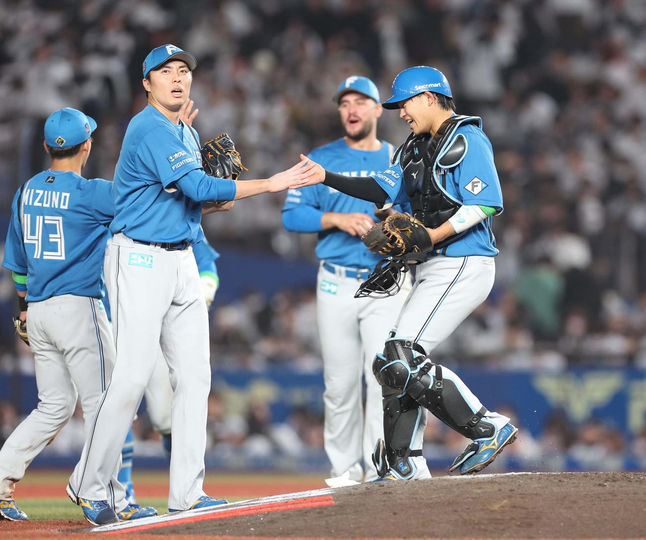 ロッテ対日本ハム　試合後、田中正（左）と握手する田宮（撮影・黒川智章）