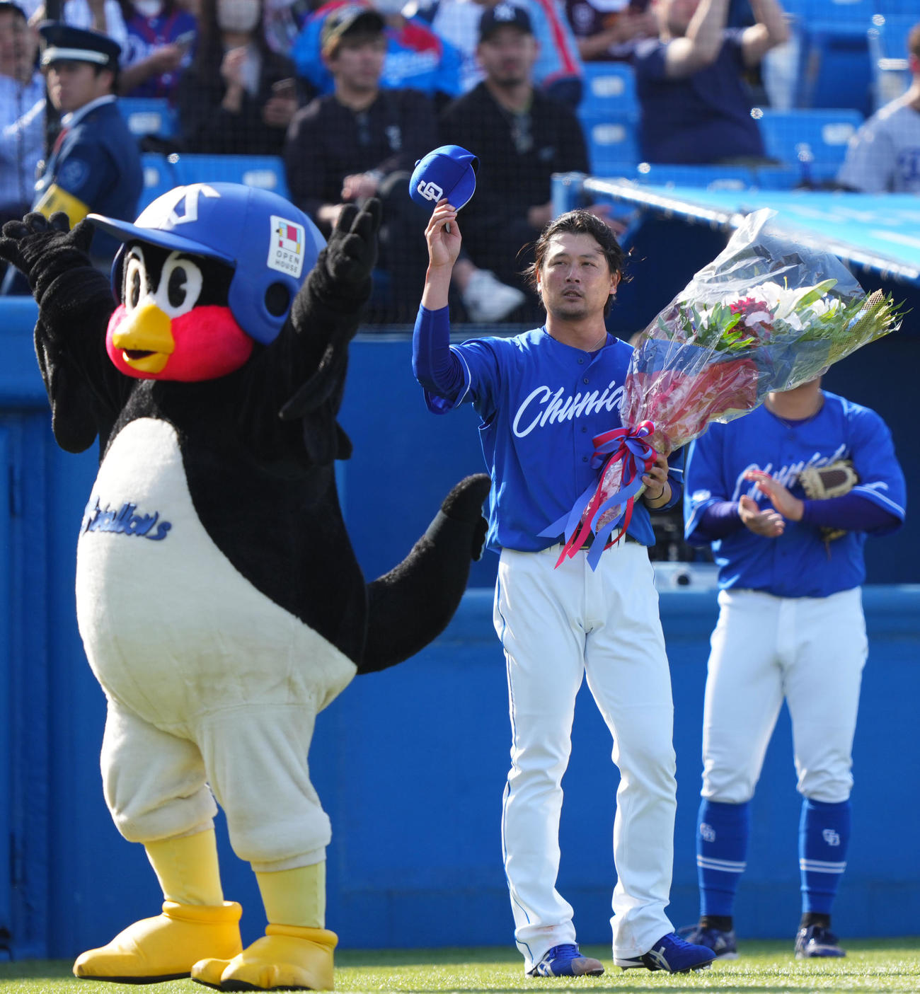 ヤクルト対中日　通算2000奪三振を達成しつば九郎（左）から花束を受け取る涌井（撮影・横山健太）