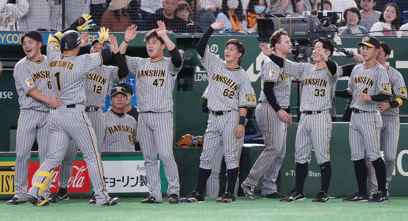 巨人対阪神　8回表阪神2死一、三塁、左中間に3点本塁打を放った森下（左から2人目）を迎える桐敷（同5人目）らベンチ（撮影・鈴木みどり）