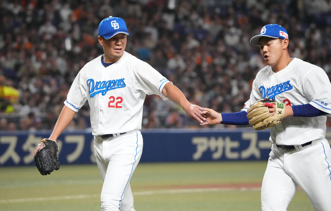 中日対巨人　2回表終了、高橋周とタッチを交わしベンチへ戻る大野（左）（撮影・森本幸一）