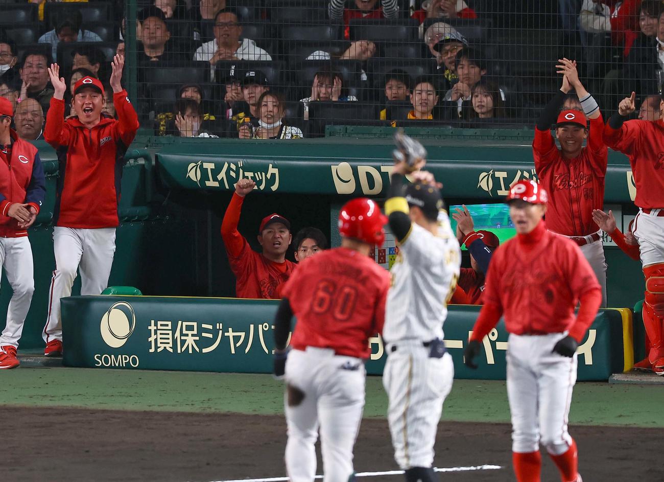 阪神対広島　9回表広島2死二塁、新井監督（左）は先制適時三塁打を放った田村（60番）に拍手を送る（撮影・上田博志）
