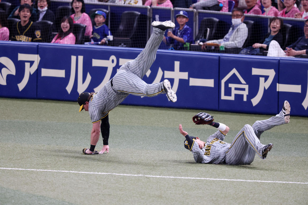 中日対阪神　i回裏中日無死、ノイジーは三好の打球を追った木浪（右）との接触を避けるためうまく身体をかわしてジャンプする（撮影・加藤哉）