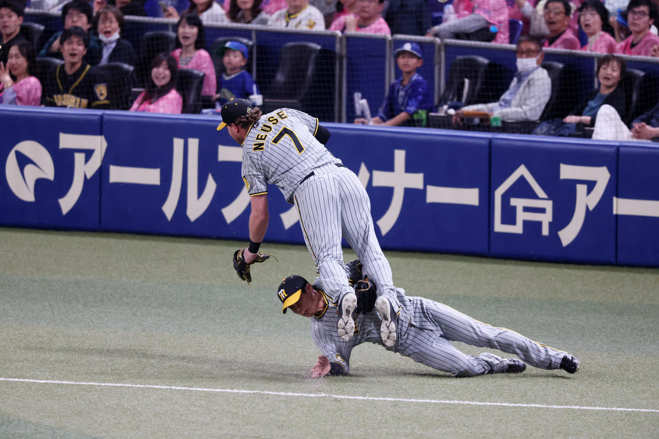中日対阪神　i回裏中日無死、ノイジーは三好の打球を追った木浪（左）との接触を避けるためうまく身体をかわしてジャンプする（撮影・加藤哉）