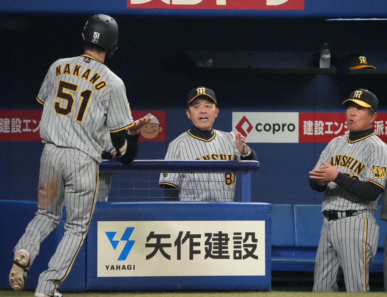 中日対阪神　3回表阪神2死一、二塁、梅野の中前適時打で生還した中野を迎える岡田監督（中央）（撮影・森本幸一）