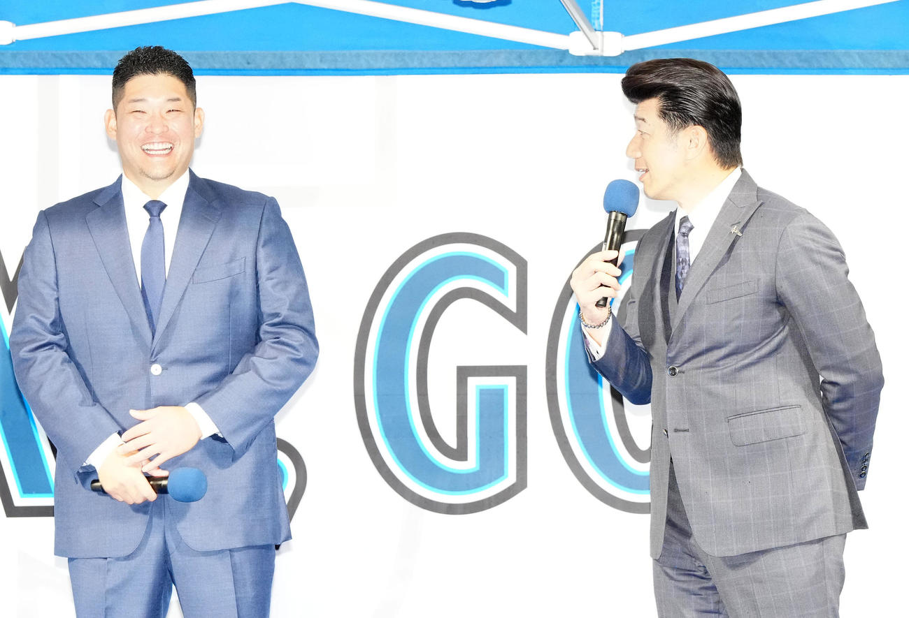 入団会見にサプライズ登場したDeNA三浦監督（右）の言葉で笑顔を見せる筒香（撮影・江口和貴）
