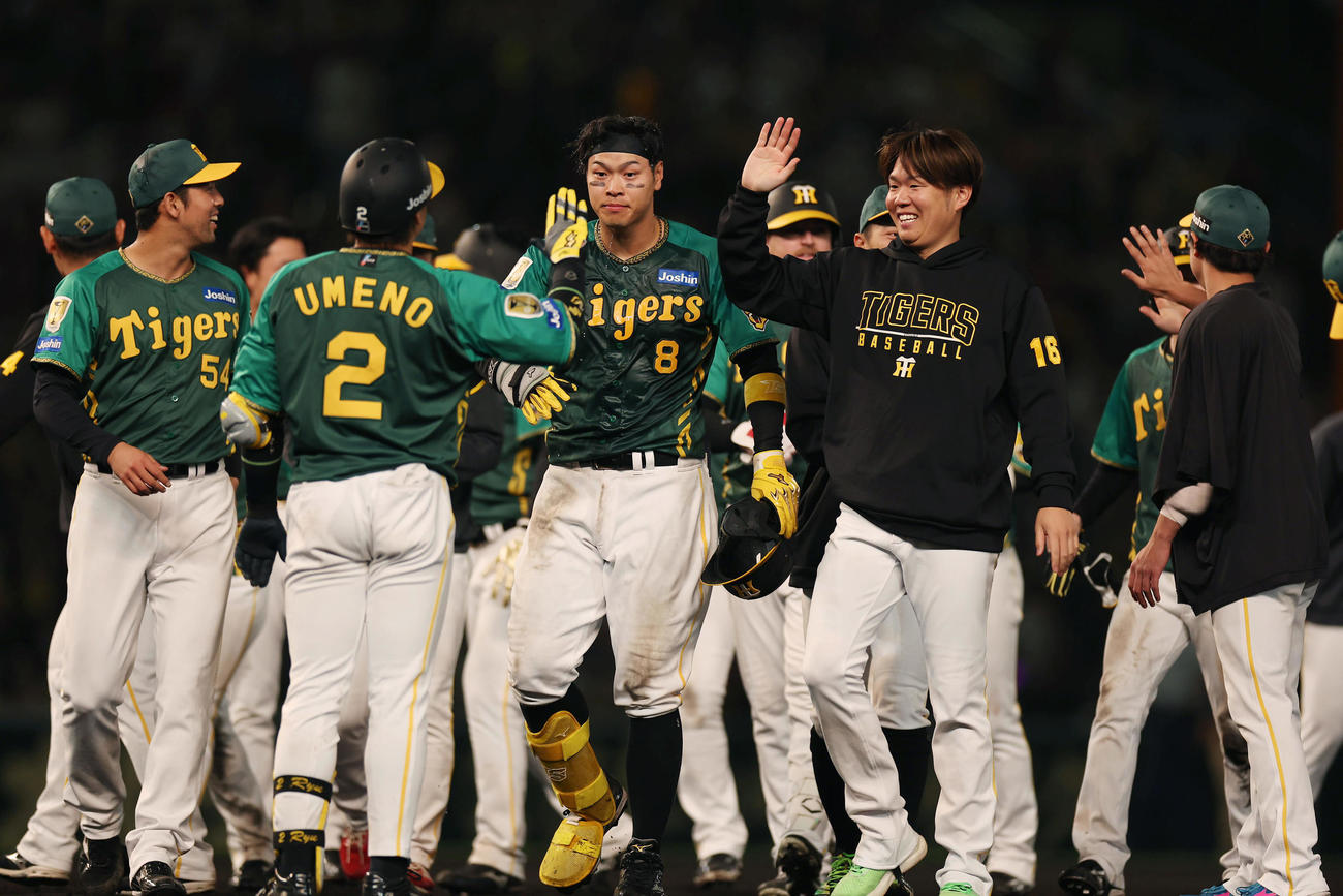 阪神対巨人　10回裏阪神無死満塁、サヨナラ適時打を放ち祝福される佐藤輝（中央）（撮影・前田充）