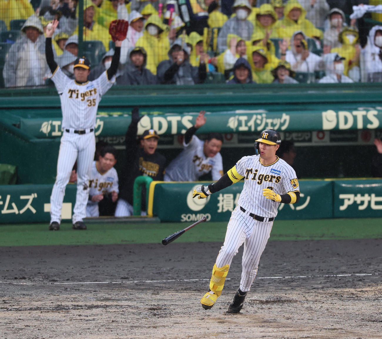 阪神対中日　6回裏阪神2死一、二塁、佐藤輝は右越え3点本塁打を放ちバットを持ったまま一塁をまわる。後方左はバンザイする才木（撮影・加藤哉）