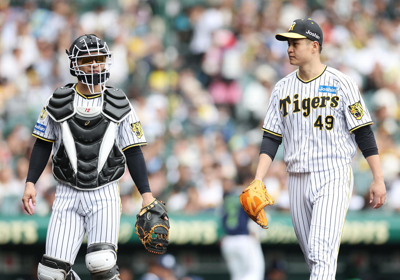 阪神対ヤクルト　4回表を終え、言葉を交わしながらベンチへ戻る阪神坂本（左）と大竹（撮影・前田充）