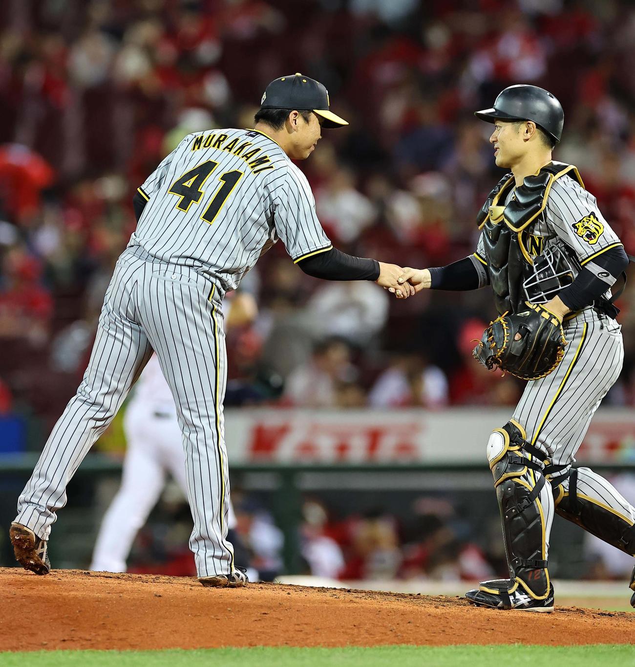 広島対阪神　完投勝利した村上（左）は坂本と握手を交わす（撮影・上田博志）