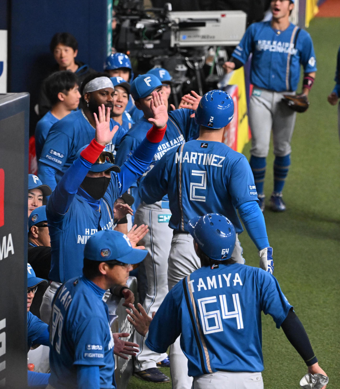 オリックス対日本ハム　1回表日本ハム2死一、二塁、万波の適時二塁打で生還したマルティネス、田宮を迎える新庄監督（撮影・和賀正仁）