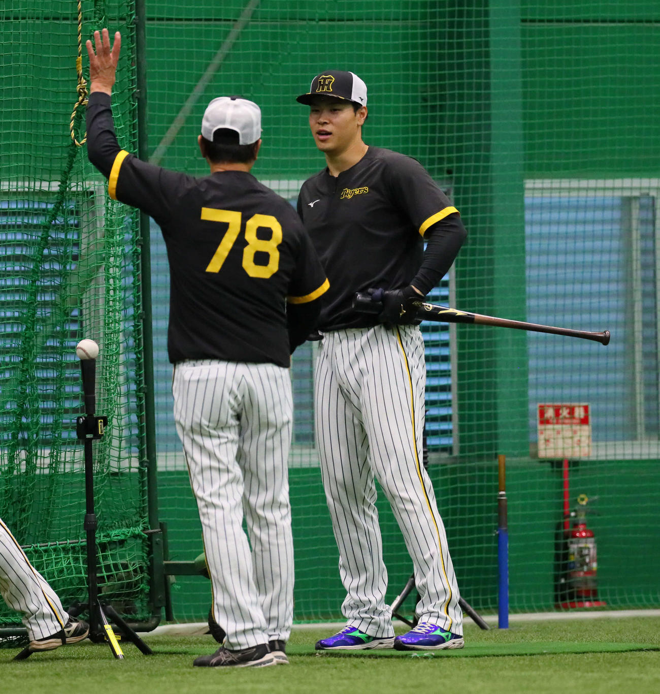 打撃練習を前に平田ヘッドコーチ（左）と話し合う佐藤輝（撮影・宮崎幸一）