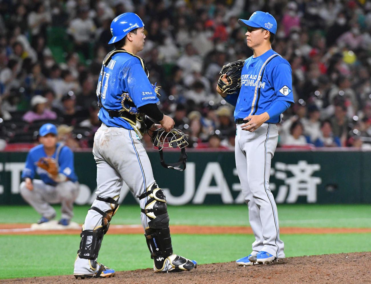 ソフトバンク対日本ハム　12回裏ソフトバンク無死満塁、周東のサヨナラ左犠飛の判定に日本ハム新庄監督がリクエストし、判定を待つ間に伏見（左）と話す矢沢（撮影・岩下翔太）