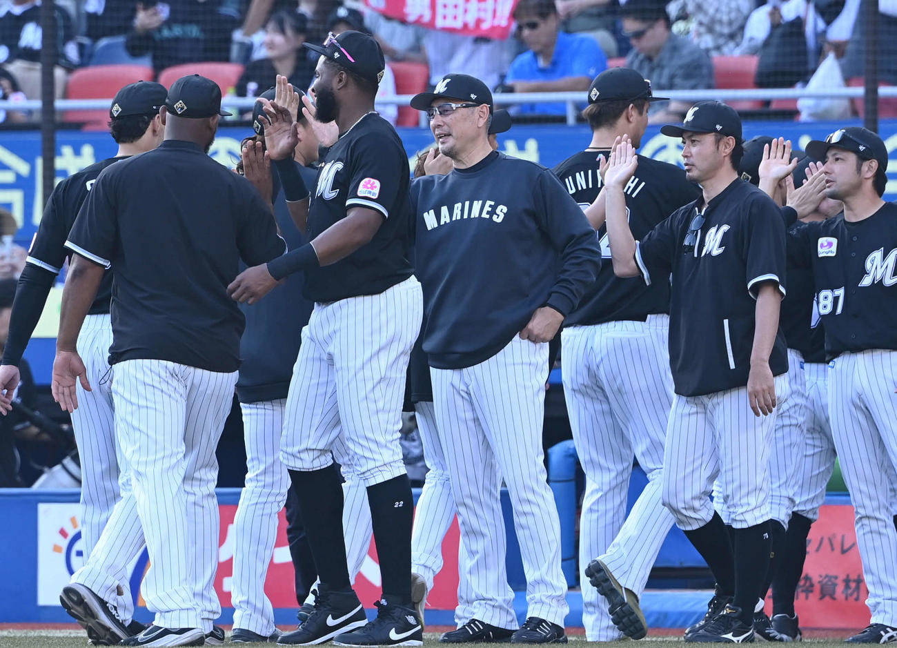 ロッテ対日本ハム　逆転勝ちしたロッテ吉井監督（中央）は選手とタッチを交わす（撮影・山崎安昭）