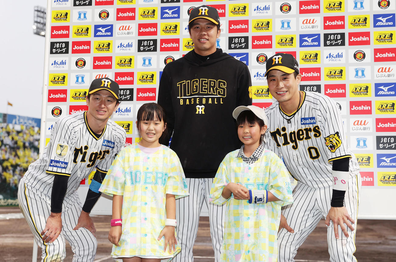 阪神対ヤクルト　お立ち台で子どもたちと並んで笑顔を見せる、左から阪神近本、才木、木浪（撮影・前田充）