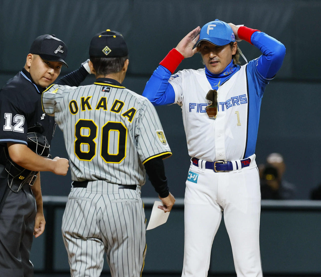 3月2日のオープン戦、試合前のメンバー表交換で阪神岡田監督（左）と言葉を交わす日本ハム新庄監督