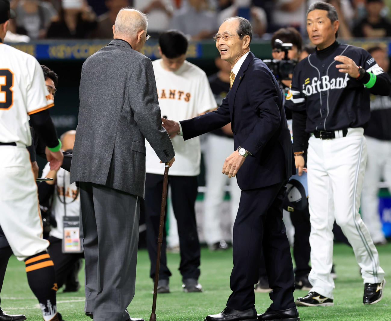巨人対ソフトバンク　王貞治デーで、グラウンドに登場したソフトバンク王貞治球団会長（右）は張本勲氏と笑顔で握手（撮影・浅見桂子）