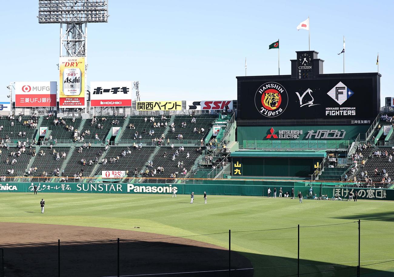 阪神対日本ハム　新庄監督（左手前）は甲子園球場のセンター付近で練習を見守る（撮影・上田博志）