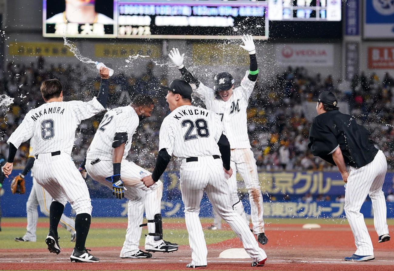ロッテ対阪神　10回裏ロッテ2死満塁、サヨナラとなる押し出し四球を選びチームメートから祝福を受ける小川（右から2人目）（撮影・横山健太）