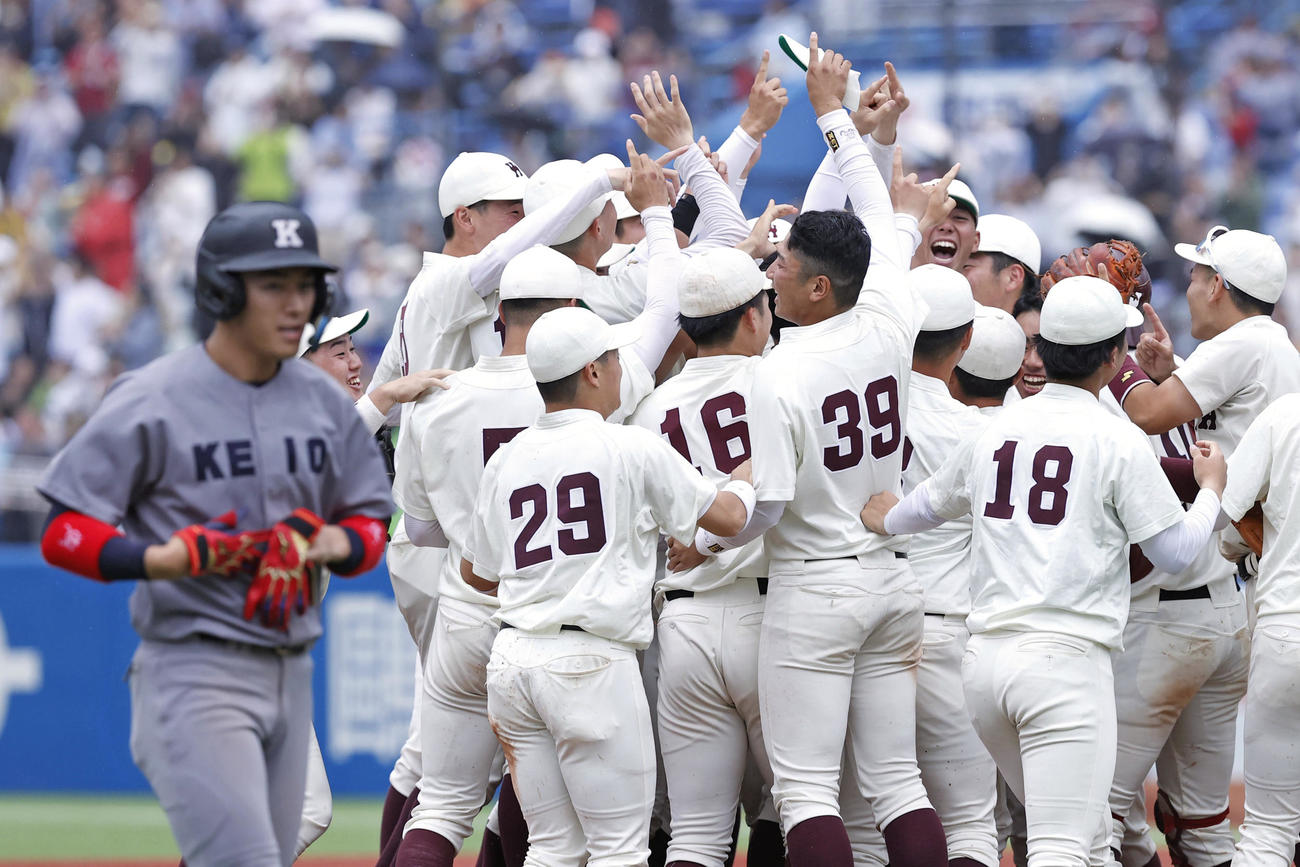 リーグ最多となる47度目の優勝を果たし、喜ぶ早大ナイン。手前は引き揚げる最終打者の慶大・清原（共同）