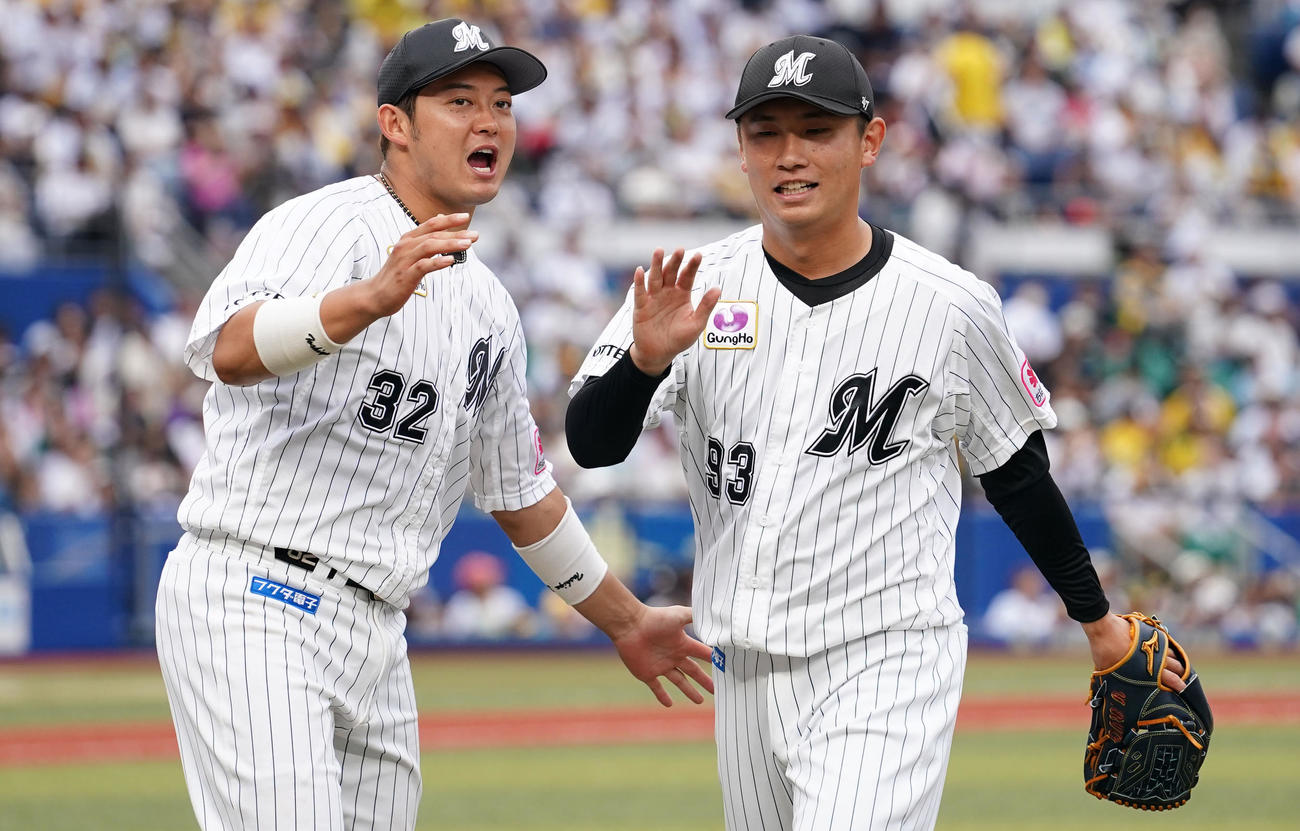 ロッテ対阪神　9回表を無失点に抑えタッチを交わすロッテ吉田。左は佐藤（撮影・横山健太）