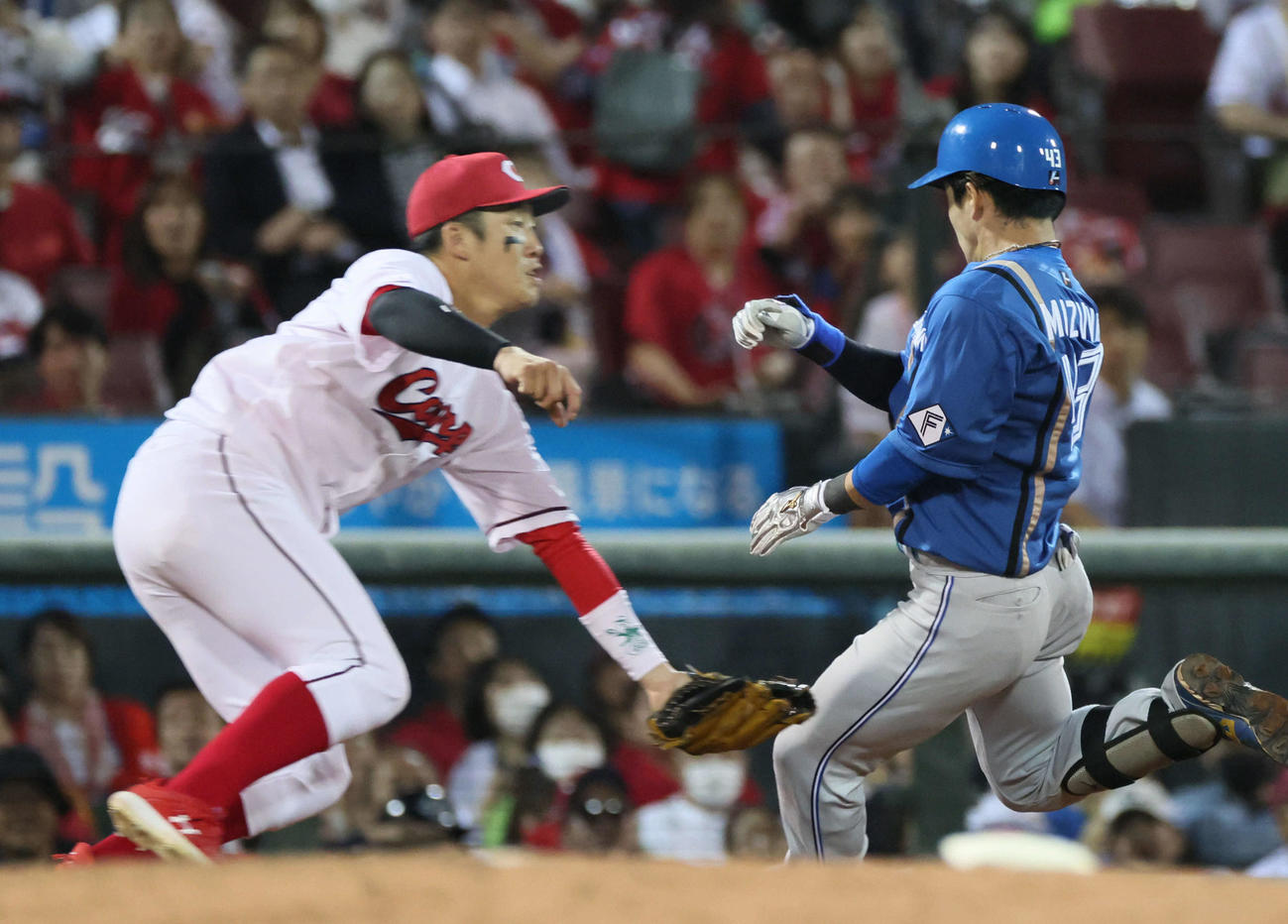 広島対日本ハム　7回表日本ハム無死、右中間越え三塁打を放った水野。左は小園（撮影・加藤孝規）
