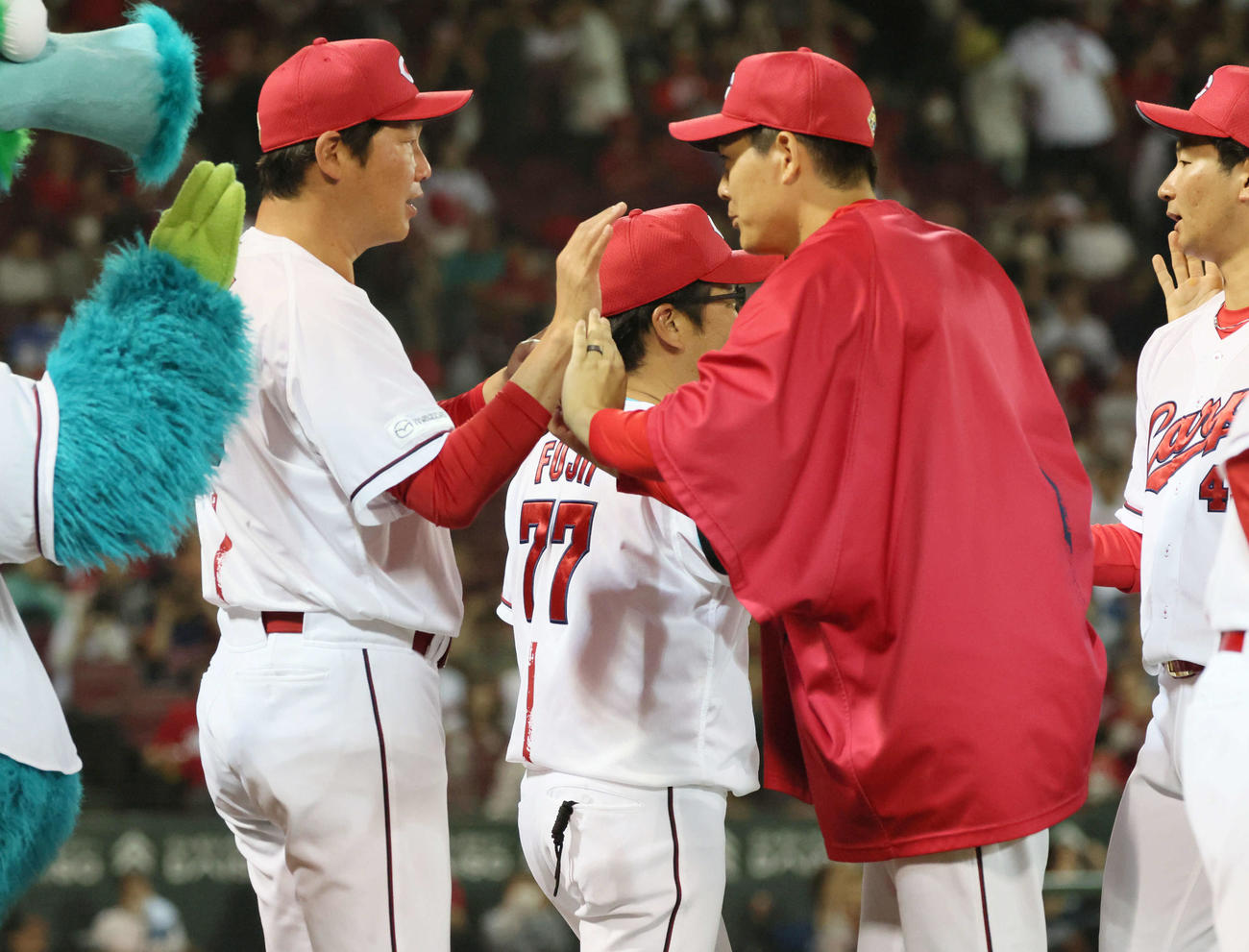 広島対日本ハム　九里（右から2人目）とハイタッチする新井監督（撮影・加藤孝規）